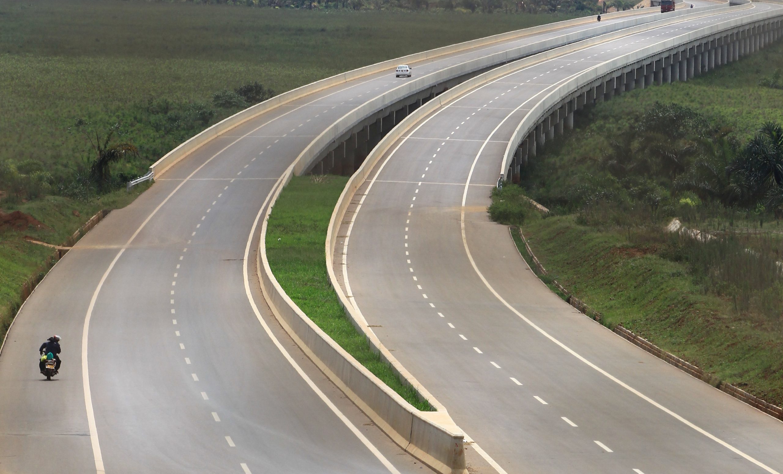 A motorbike rides on a bridge over swamp on the new Chinese-built 51-kilometer (31 miles) four-lane expressway connecting Uganda's capital Kampala to Entebbe International Airport, in Kampala, Uganda January 29, 2018. REUTERS/James Akena